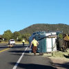 Driver Arrested After Truck Towing Hay Overturns