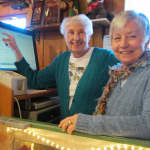 Volunteer gift shop manager Ruth Clem and treasurer Sheila Wymore examine new Sedona Heritage Museum computer system