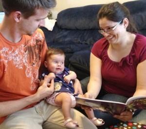 Clint and Maria Slay read to their 4-month old daughter Liliana, one of the thousands of children participating in programs funded by the Yavapai Regional Partnership Council.
