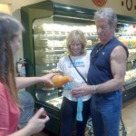 Sedona visitors Lisa Livingstone and Ken Ludwig of Golden Colorado sample iced coffee offered by former 3 yr New Frontiers employee now Whole Foods local store Marketing Director Sabrina Pierson